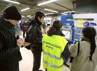 Una <i> euroinformadora</i> ayuda a los usuarios en la estación de metro de Sol.