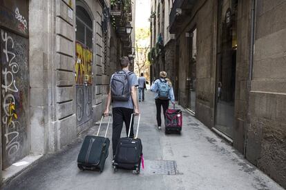 Turistas con maletas en el distrito de Ciutat Vella de Barcelona.