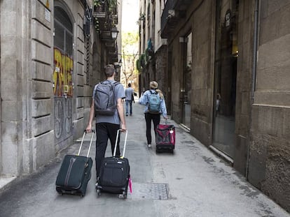 Turistas con maletas en el distrito de Ciutat Vella de Barcelona.