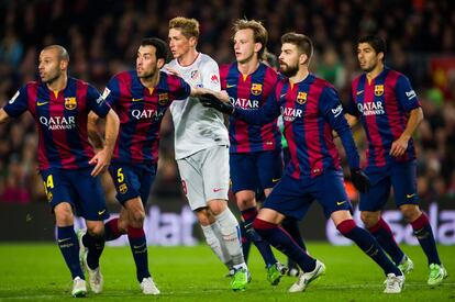 Otra imagen del eléctrico partido ante los rojiblancos, con buena parte de la zaga azulgrana defendiendo un balón aéreo ante Fernando Torres.