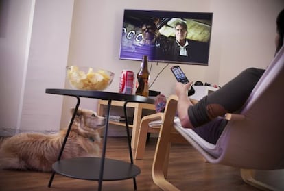 A woman watches the trailer for the new ‘Star Wars’ movie on her TV.