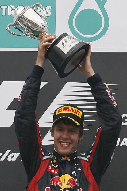 Vettel posa con el trofeo que le acredita como ganador del Gran Premio de Malasia.