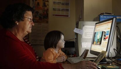 Una àvia amb la seva neta, davant l'ordinador.