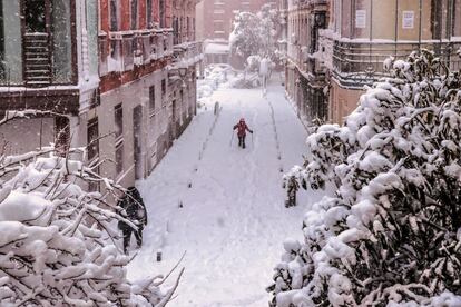 Una persona intenta avanzar sobre la nieve en una calle de Madrid. 