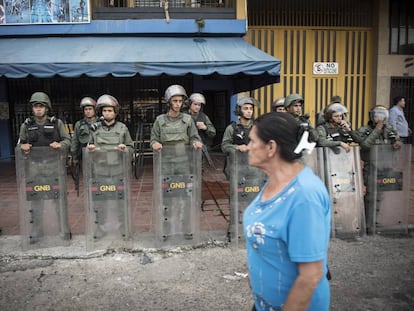 Agentes da Guarda Nacional Bolivariana protegem uma loja em Táchira.