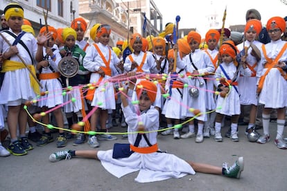 Jóvenes indios de la religión sij muestran sus habilidades en el arte marcial conocido como 'gatka' durante una procesión desde Akal Takht al Templo de Oro en Amritsar (India).