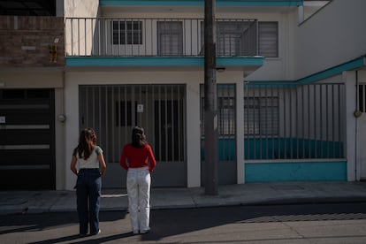 Two young activists in front of the house where false feminist organizations operated, in Orizaba, Mexico, in December 2023. 