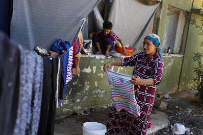 A Syrian Kurdish woman hangs out washing at Ritsona refugee camp north of Athens, which hosts about 600 refugees and migrants on Monday, Sept. 19, 2016. The European Union's border agency says the number of migrants arriving in the Greek islands has increased significantly over the last month.(AP Photo/Petros Giannakouris)