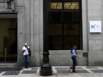 Dos personas, frente al edificio de la Bolsa de São Paulo.