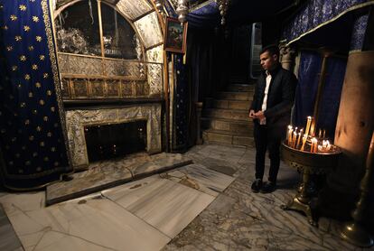A young man prays in front of the manger, the place where, according to the Bible, Jesus was born, in the Basilica of the Nativity in the city of Bethlehem, December 10. 