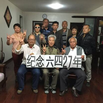 Sun Wenguang, sentado en el centro, junto a sus amigos en el homenaje que realizó en su casa. En la pancarta se puede leer: "27º aniversario del 4 de junio".