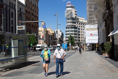 Passers-by with face masks on Madrid's Gran Vía earlier this month.