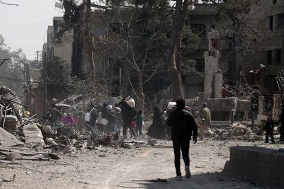 Un grupo de personas abandonan la ciudad siria de Hamouria, en el este de Guta (Siria), el 15 de marzo de 2018.