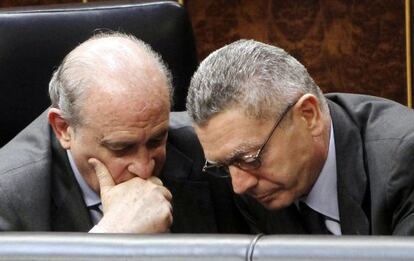 Fernández Díaz, a la izquierda, conversa con el ministro de Justicia, Alberto Ruiz Gallardón, en el Congreso.