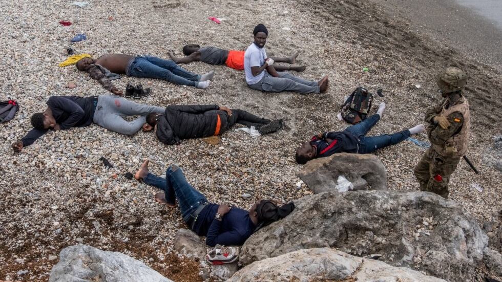 Un soldado custodiaba a varios jóvenes inmigrantes, algunos de ellos heridos, en la playa del Tarajal, en la frontera de Ceuta. 