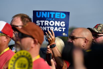 A member holds up a sign at a rally by United Auto Workers Local 863 in Louisville, Ky., on Aug. 24, 2023.
