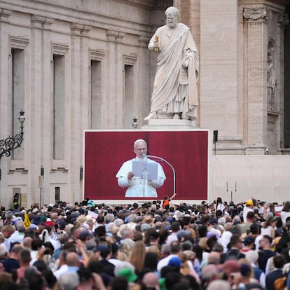 People watch Pope Leo XIV on a giant screen as he delivers his blessing from the central balcony of St. Peter's Basilica for his first Sunday blessing after his election, in St. Peter's Square at the Vatican, Sunday, May 11, 2025.(AP Photo/Andrew Medichini)