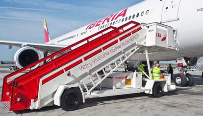 Varios trabajadores de Iberia preparan la salida de un A330 en el aeropuerto madrile&ntilde;o de Barajas.