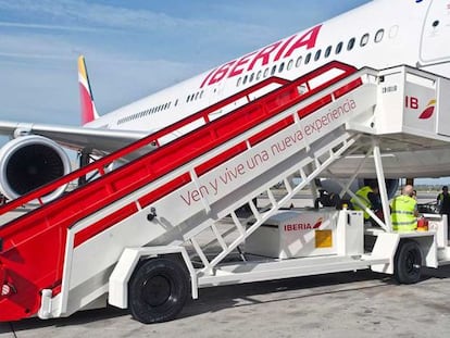 Varios trabajadores de Iberia preparan la salida de un A330 en el aeropuerto madrile&ntilde;o de Barajas.