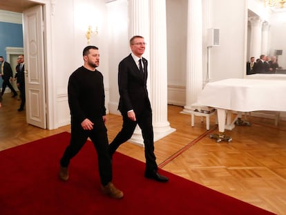Ukrainian President Volodymyr Zelenskiy and Latvian President Edgars Rinkevics walk after holding a joint press conference in Riga, Latvia, 11 January 2024.
