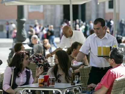 Un camarero sirve bebidas, en una terraza de Valencia.