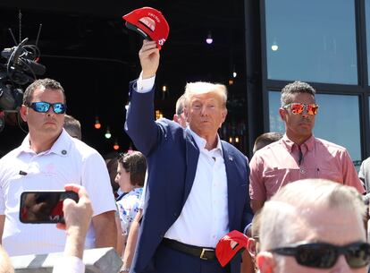 Former US President Donald J. Trump (C) attends the Iowa State Fair in Des Moines, Iowa, USA, 12 August 2023.