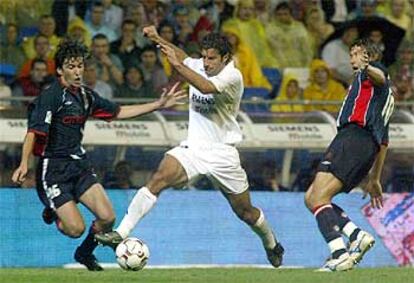 Figo conduce el balón entre Mostovoi y Silvinho durante el encuentro de ayer.