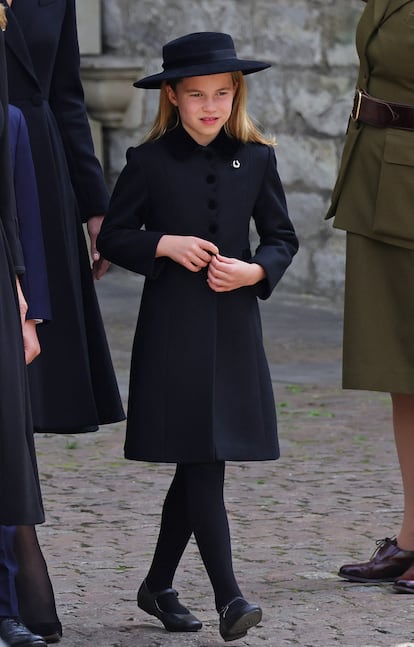 Princess Charlotte, wearing a horseshoe brooch, leaves Westminster Abbey on September 19, 2022 after Elizabeth II's state funeral.