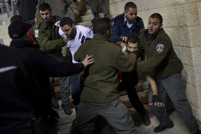 Israeli security forces detain Bnei Sakhnin supporters during a game against Beitar Jerusalem F.C. at the Teddy Stadium in Jerusalem, Sunday, Feb. 10, 2013. Hundreds of police deployed around Beitar Jerusalem's stadium, two days after a suspicious fire believed to be set by angry fans destroyed the team's main offices. Tensions remained high Sunday as the team faced off with Bnei Sakhnin, an Arab team whose fans have clashed before with Beitar's. (AP Photo/Bernat Armangue)