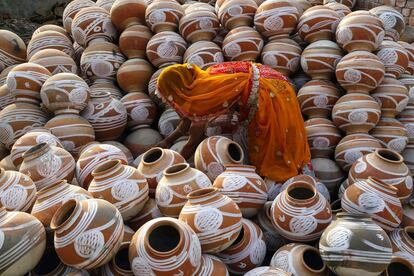 Una mujer coloca vasijas en Ajmer (India).