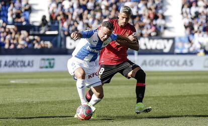 Roque Mesa protege el balón ante Salva Sevilla.