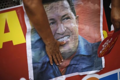 A Ch&aacute;vez supporter touches a campaign poster of the president during a PSUV rally Sunday