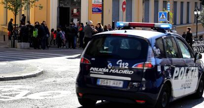 Un coche de la Policía Municipal pasa por delante de un colegio, en una imagen de archivo.