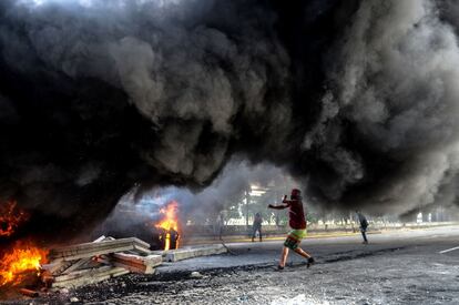 Venezuela vive desde el pasado 1 de abril una ola de manifestaciones a favor y en contra del Gobierno, algunas de las cuales han terminado con hechos de violencia, dejando un saldo de 75 muertos y más de mil heridos, según datos de la Fiscalía. En la imagen, un joven lanza un objeto a los militares durante los enfrentamientos frente a la base militar de La Carlota en Caracas.