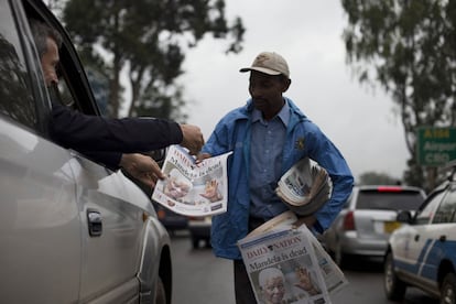 Um homem vende jornais em uma rua de Nairobi (Quênia), 6 de dezembro de 2013. A tristeza pela morte do ex-presidente sul-africano Nelson Mandela contagia toda a África do Sul, que lhe expressa sua gratidão e chora em todos os cantos pela perda do pai de sua democracia multirracial.