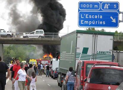 Unos conductores observan el accidente en la AP-7, cerca de Girona.