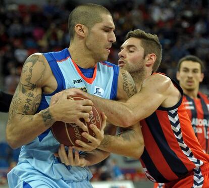 El ala-pívot del Estudiantes Nacho Martín lucha por el balón con el escolta del Laboral Kutxa Fabien Causeur.