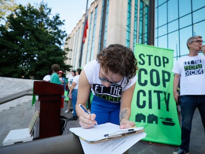 Activists gather outside Atlanta City Hall, Monday, Sept. 11, 2023, where they delivered dozens boxes full of signed petitions to force a referendum on the future of a planned police and firefighter training center.