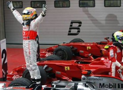 Hamilton celebra su victoria en Shanghai mientras Massa abandona su coche.