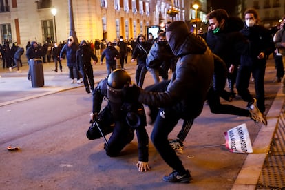 A riot officer is kicked by demonstrators in Madrid's Puerta del Sol.