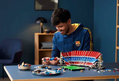 Una persona construyendo el modelo de LEGO del Camp Nou