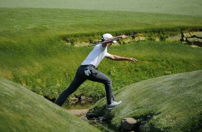 El canadiense Mike Weir cruza un riachuelo en el hoyo 13.