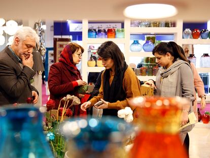 Women with and without the veil at the Tehran International Tourism Exhibition, on February 8, 2023