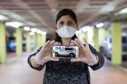 Silvana Bonino shows a photo of her vandalized car.