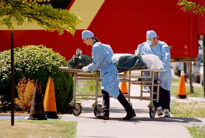 Workers at the Cook County morgue in Chicago wheel a body to refrigerator trucks on Tuesday, July 18, 1995. As heat waves fueled by climate change arrive earlier, grow more intense and last longer, people over 60 who are more vulnerable to high temperatures are increasingly at risk of dying from heat-related causes.