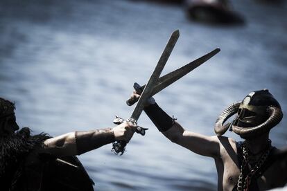 En la imagen, dos participantes disfrazados de vikingos, representan una batalla cerca del mar, en Catoira, Pontevedra.