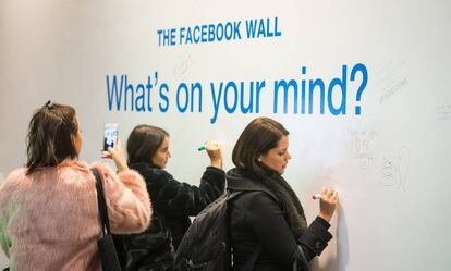 Empleados de Facebook escriben mensajes en un muro de la sede de la compa&ntilde;&iacute;a en Londres.