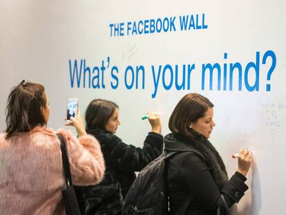 Empleados de Facebook escriben mensajes en un muro de la sede de la compa&ntilde;&iacute;a en Londres.