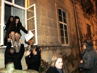 Councilors in Ponteareas make their escape through a back window of the town hall as demonstrators clashed with police. 