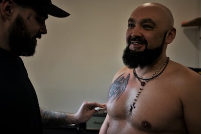 Vitali, 38, takes advantage of a rest day to get his first tattoo in the city of Kharkiv.